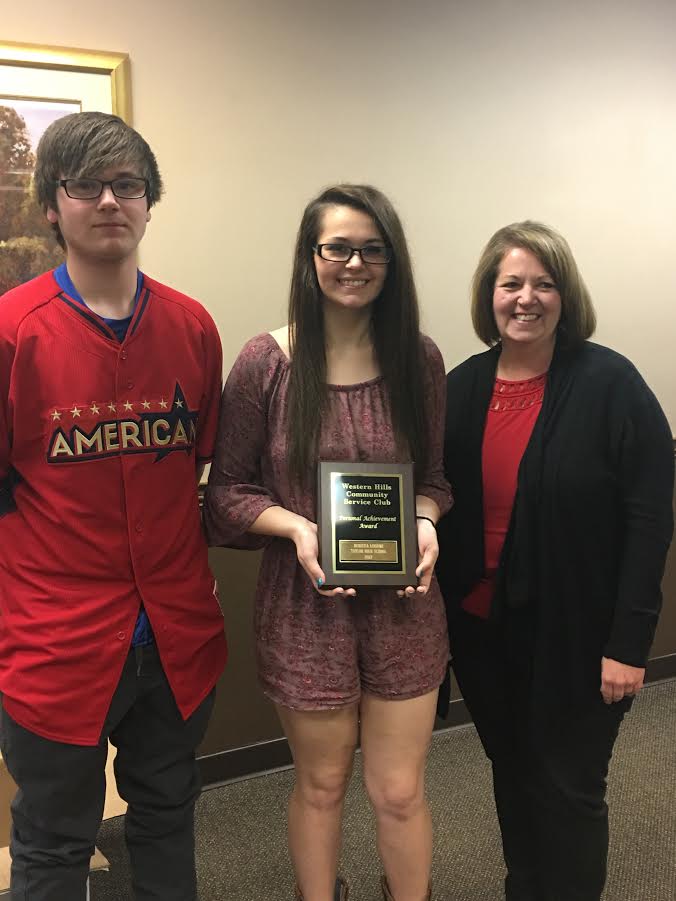 picture of taylor high school student with her family after receiving a personal achievement award